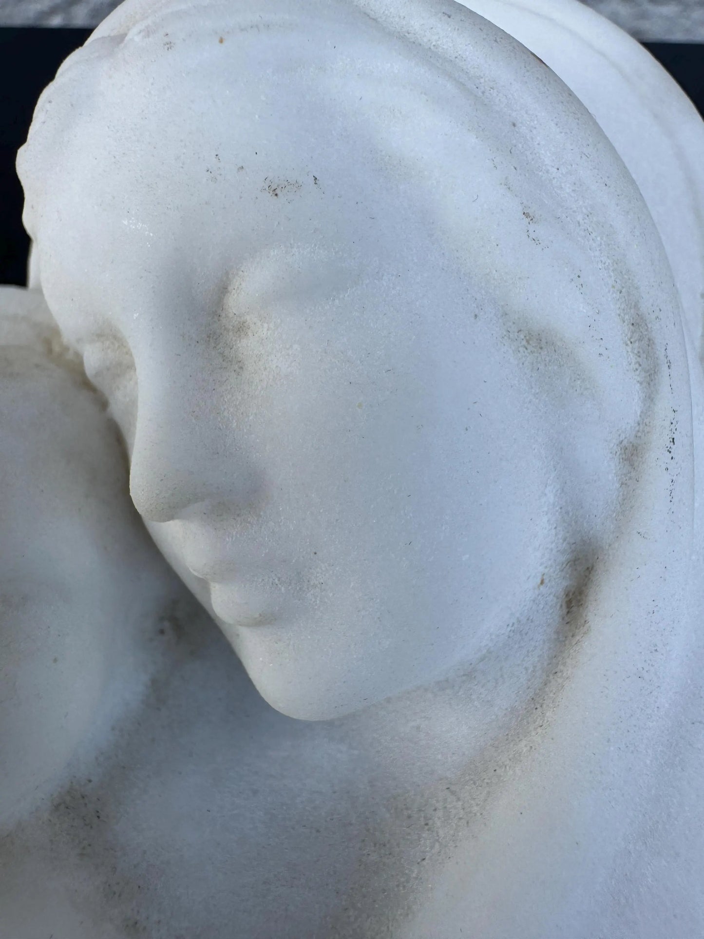 White Marble Relief of Madonna and Child on Black Slab